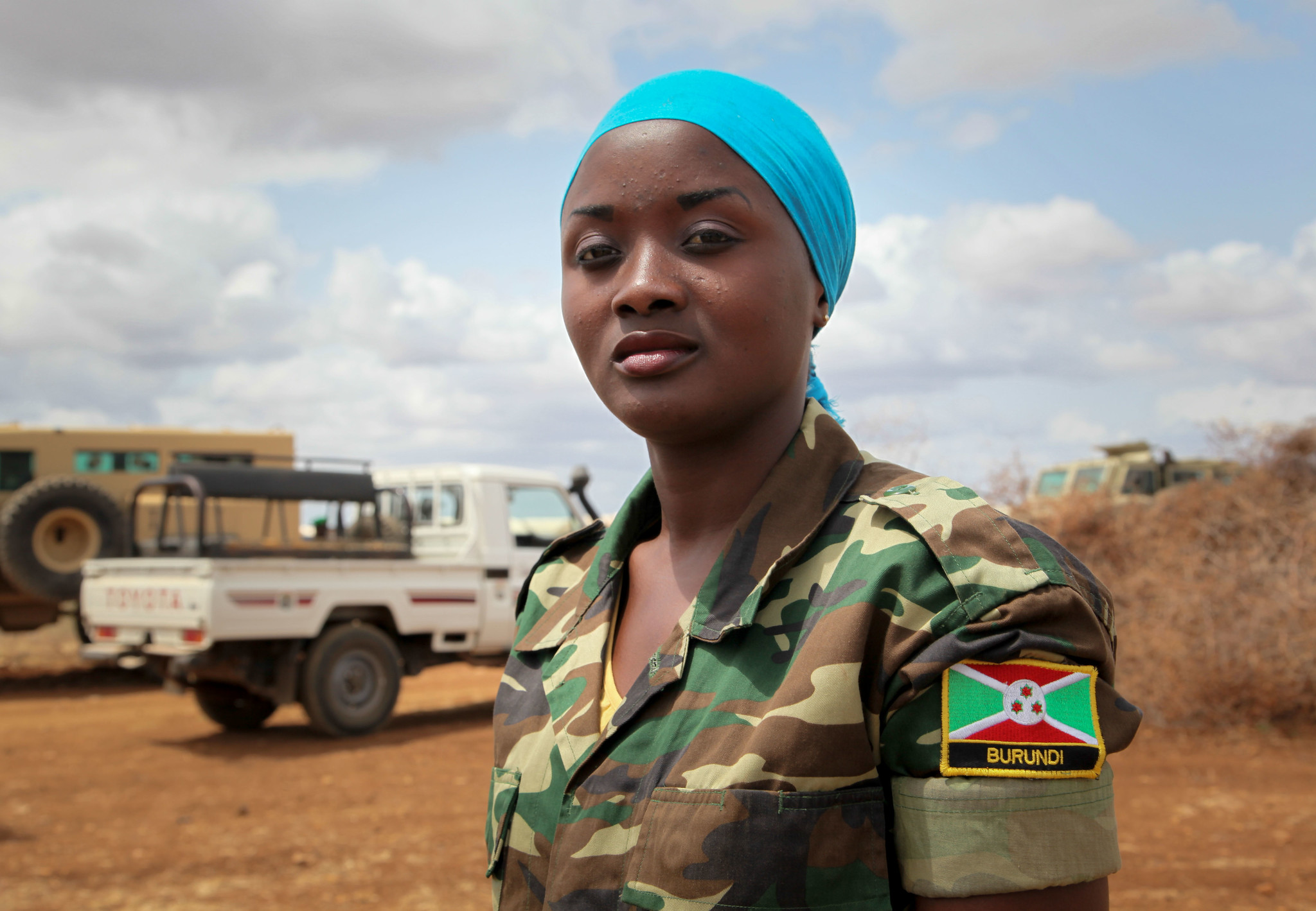 A female Burundian soldier serving with AMISOM stands at attention at Baidoa Airport, Somalia, awaiting the arrival of Burundi Chief of Defence Forces, Major General Prime Niyongabo, on 30 August 2013.