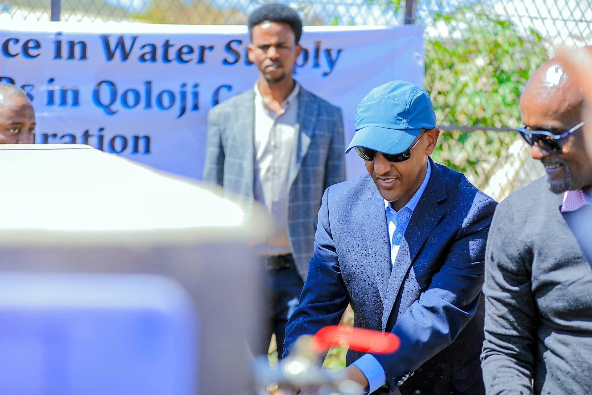 This picture shows the President of SR inaugurating a water supply project, as he opens the water flow