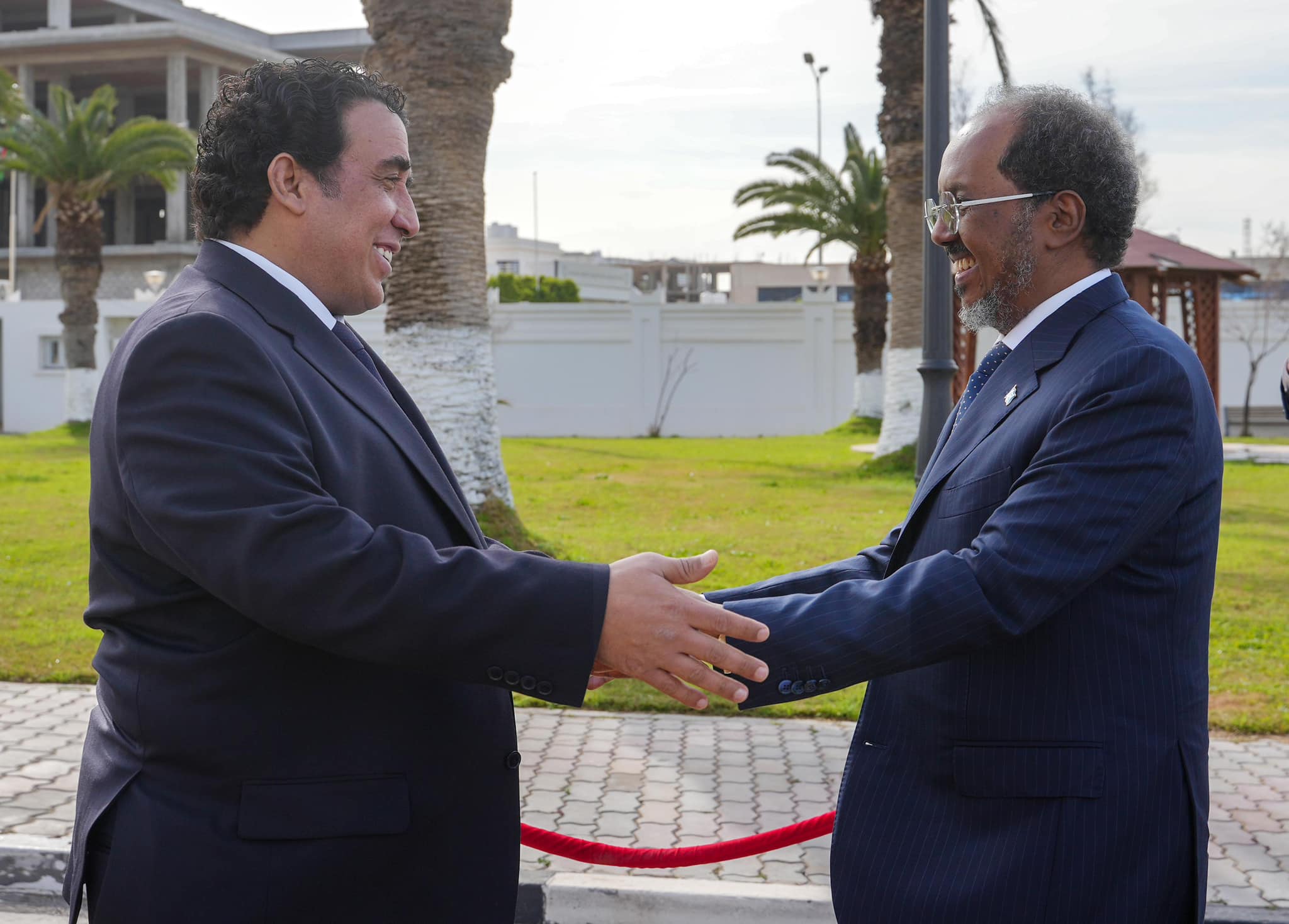 President of Somalia Hassan Sheikh Mohamud warmly greets Libyan Presidential Council Head Mohamed al-Menfi during an official visit.