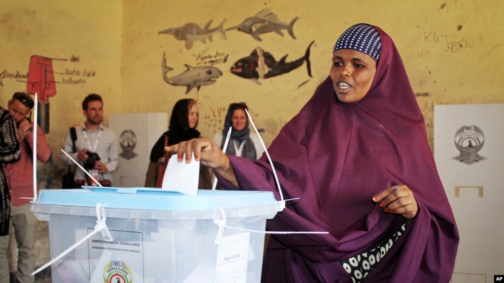 A Woman Casting Her Vote in the Somaliland Election as International Observers Monitor the Process"