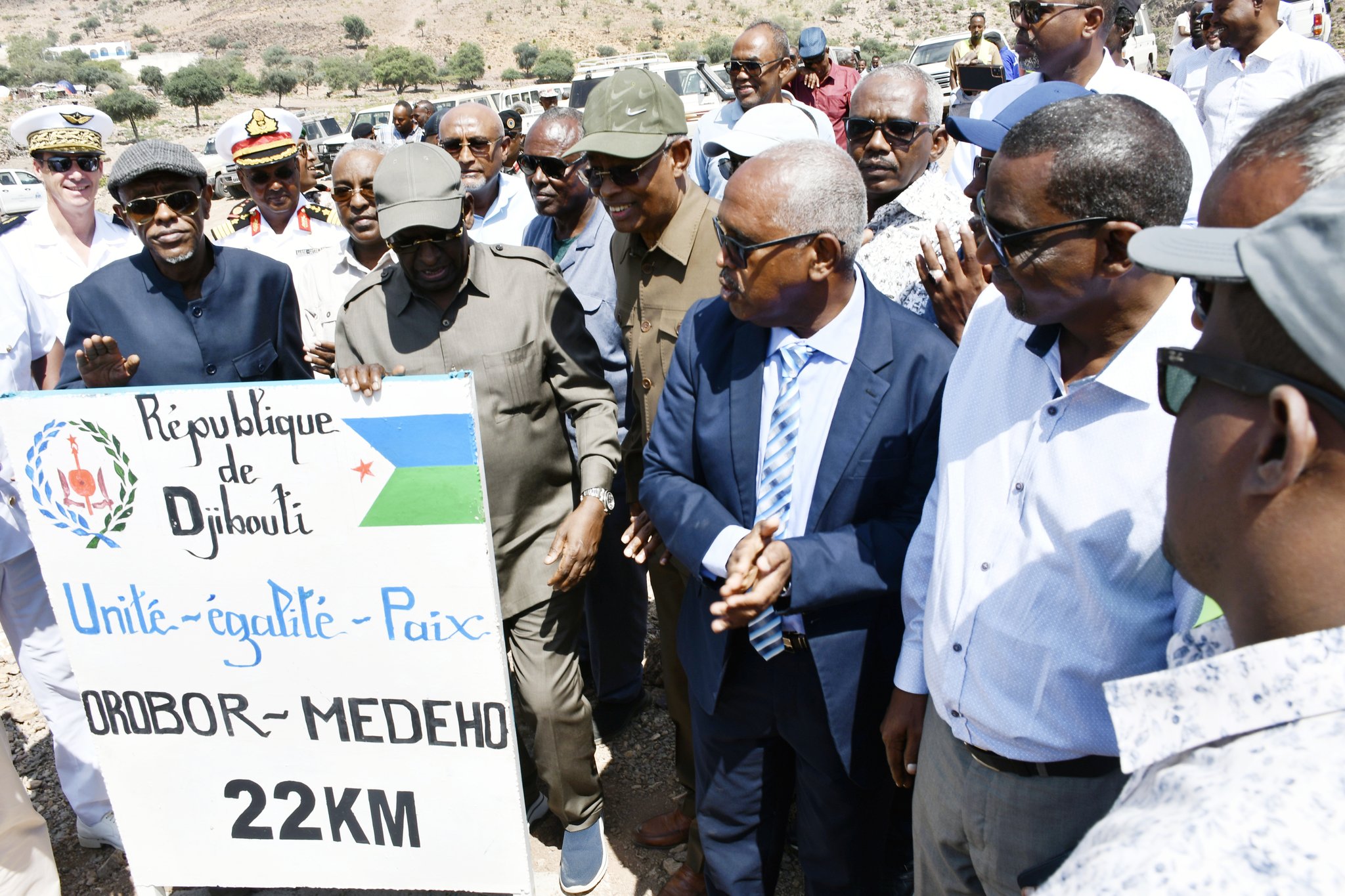 Officials and representatives from Djibouti and the European Union gather for the inauguration of the road connecting Orobor and Medeho in Djibouti. A signboard displaying the Djiboutian flag and the words "Unité - égalité - Paix" (Unity - Equality - Peace) is prominently visible.