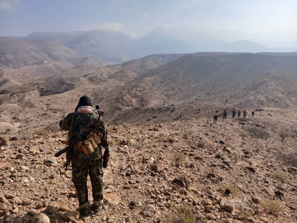 A group of Puntland security forces patrolling the rocky and mountainous terrain of Calmiskaad, Somalia.