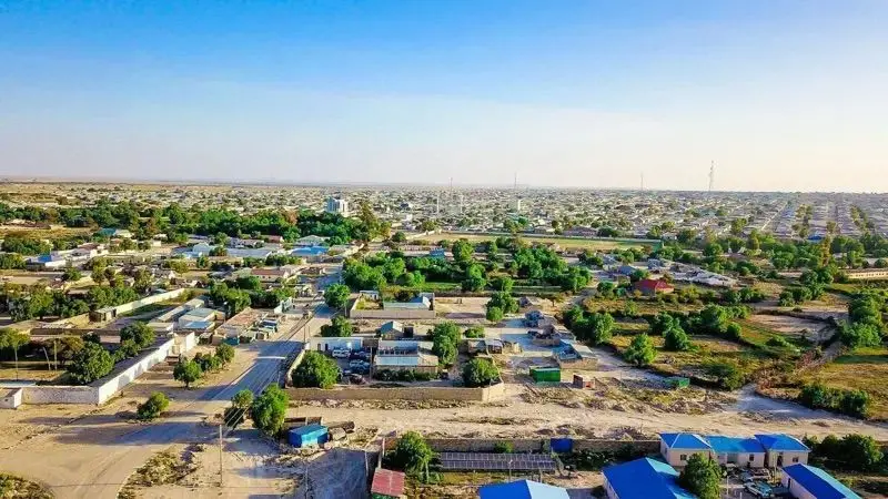 An aerial view of Ceerigaabo city, showcasing buildings, lush greenery, and well-planned roads.