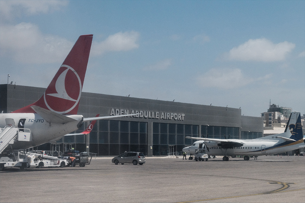 Planes, including Turkish Airlines, stationed at Aden Adde International Airport as AUSSOM condemns a mortar attack targeting the airport.