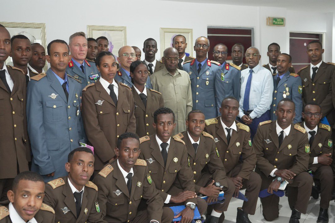 A group of Djiboutian military officers and cadets posing for a group photo alongside senior officials and international military personnel.