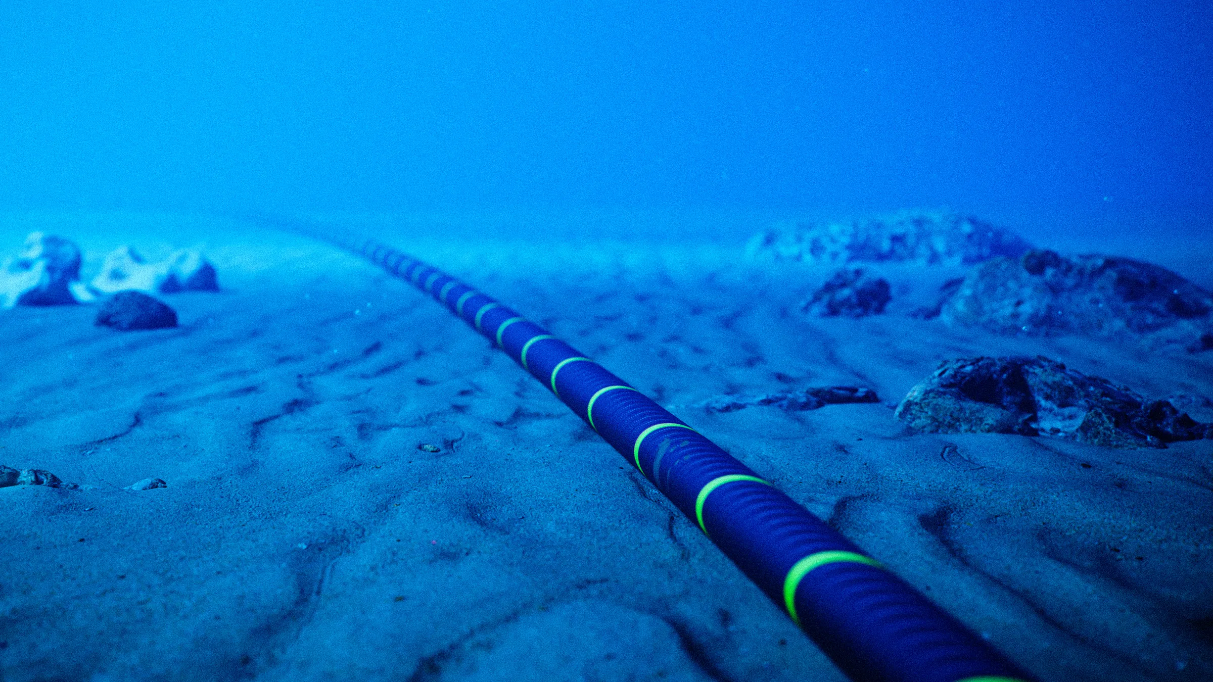 A fiber optic cable laid under the sea, connecting global networks.