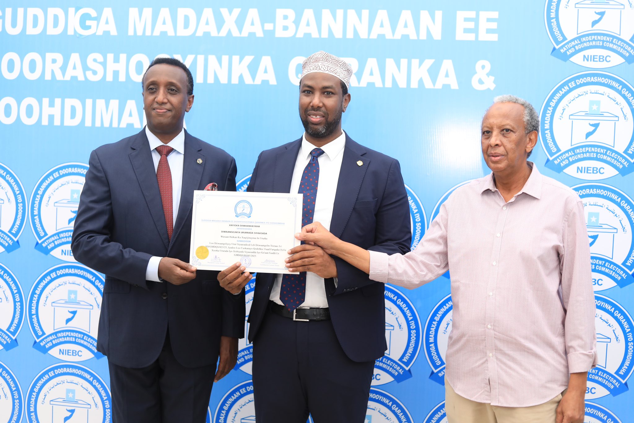 Chairman of the National Independent Electoral and Boundaries Commission (NIEBC), Abdikarim Ahmed Hassan, and other commission members attending an event where six political parties were awarded registration certificates.