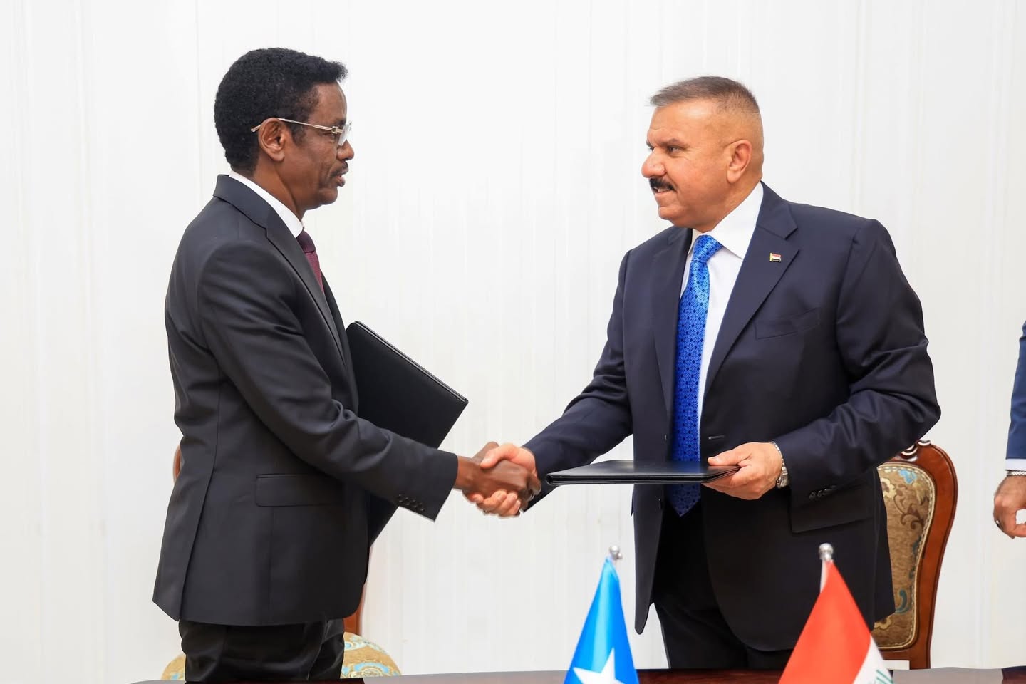 Somalia’s Minister of Internal Security and Iraq’s Minister of Interior signing a security cooperation agreement.