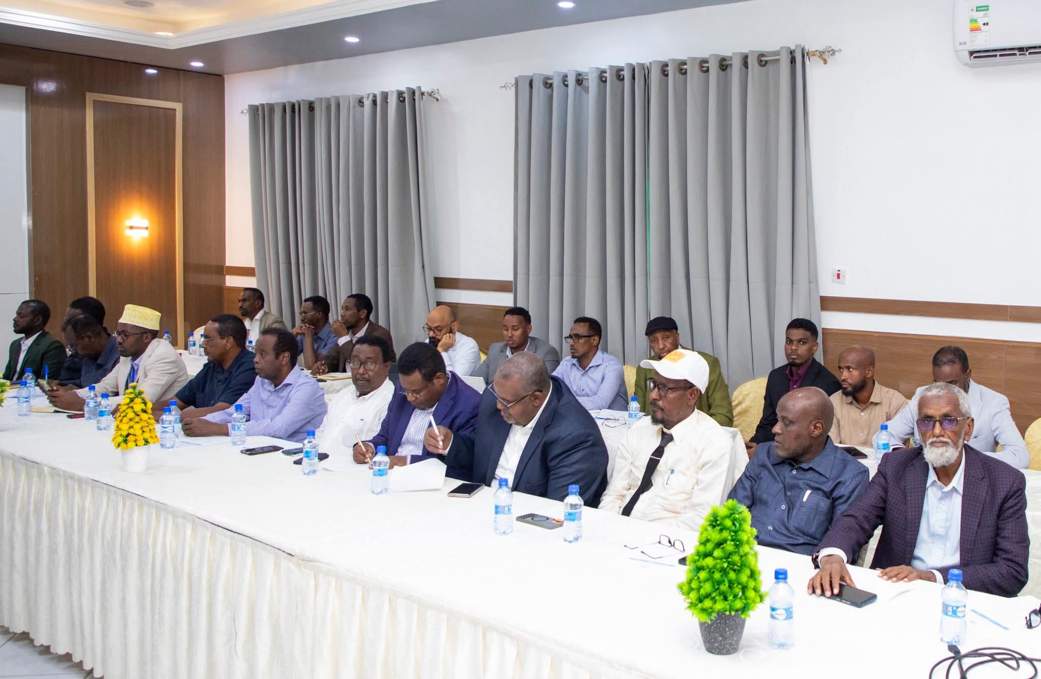 Somali government officials and registered political party representatives seated at a consultative meeting on preparations for the National Consultation Forum.