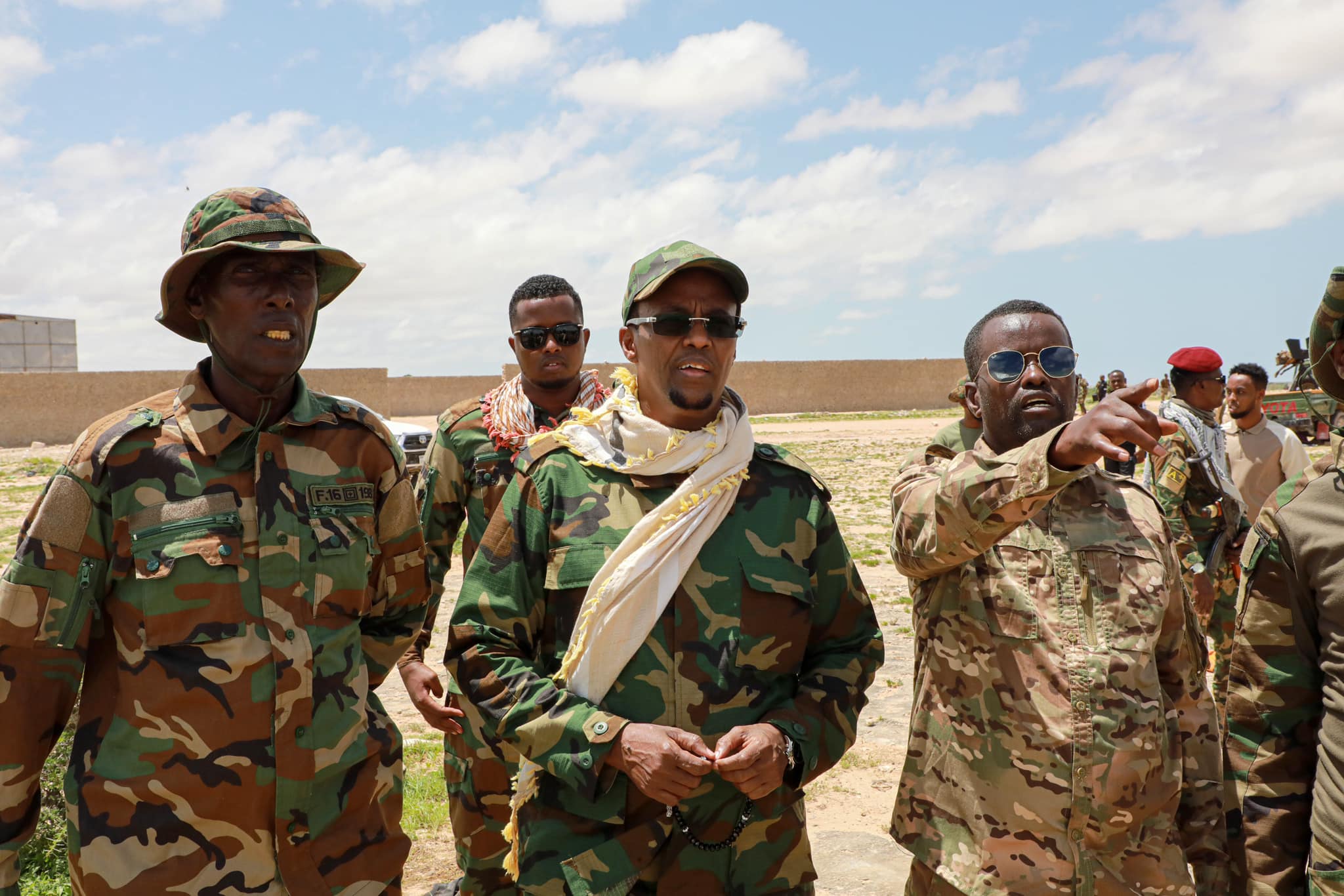 President of Hirshabeelle in military uniform inspects troops alongside commanders during the announcement of a unified offensive against Al-Shabaab.