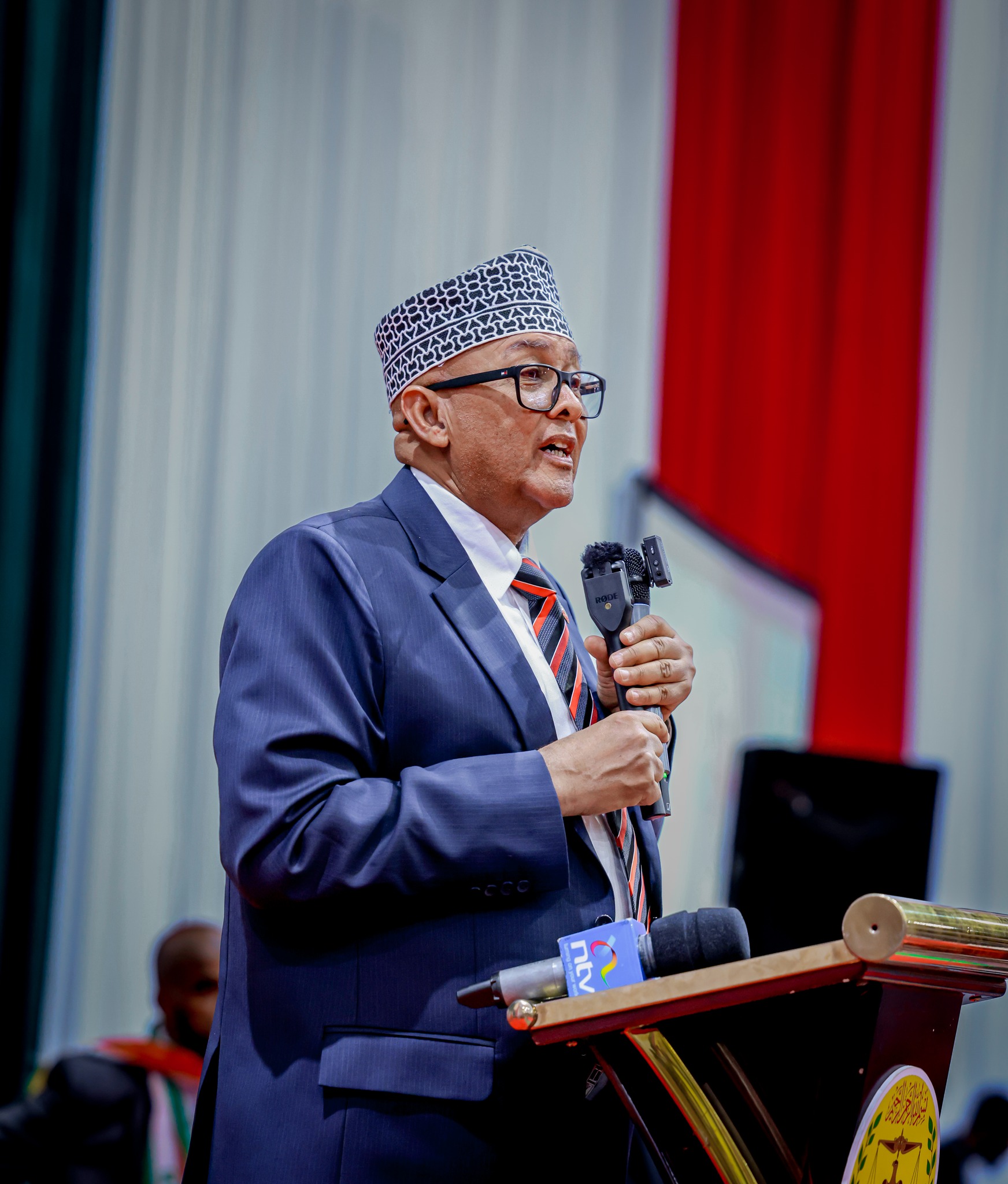 President Abdirahman Mohamed Abdullahi (Cirro) delivering a speech at the Somaliland Independence Day celebration in Nairobi, Kenya, with a backdrop displaying the Somaliland flag.